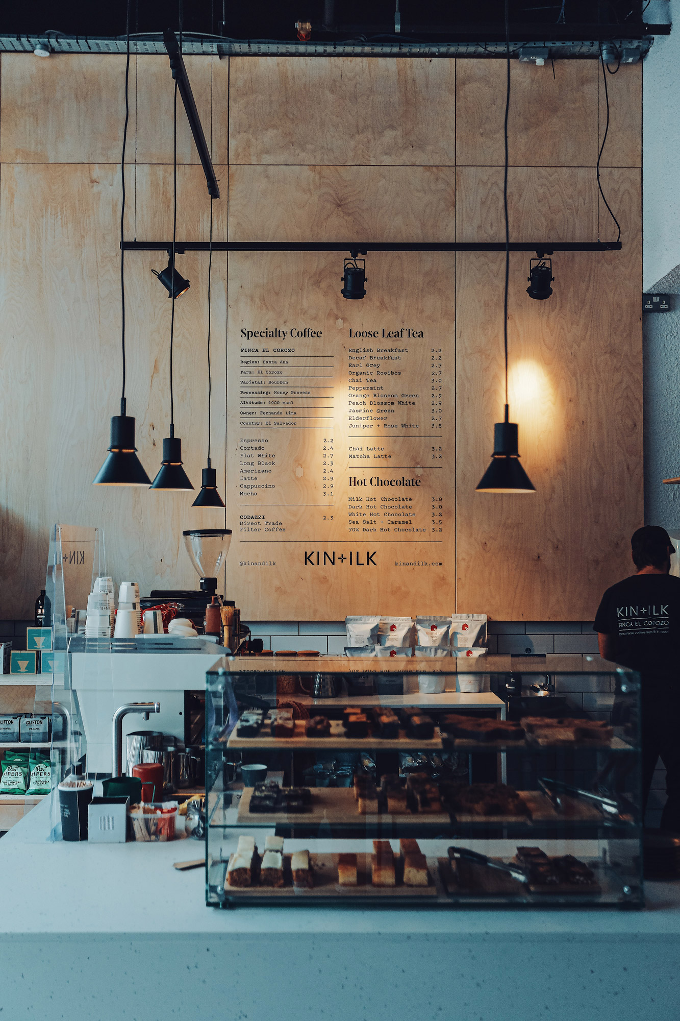 Coffee counter with lamps and counter top display.